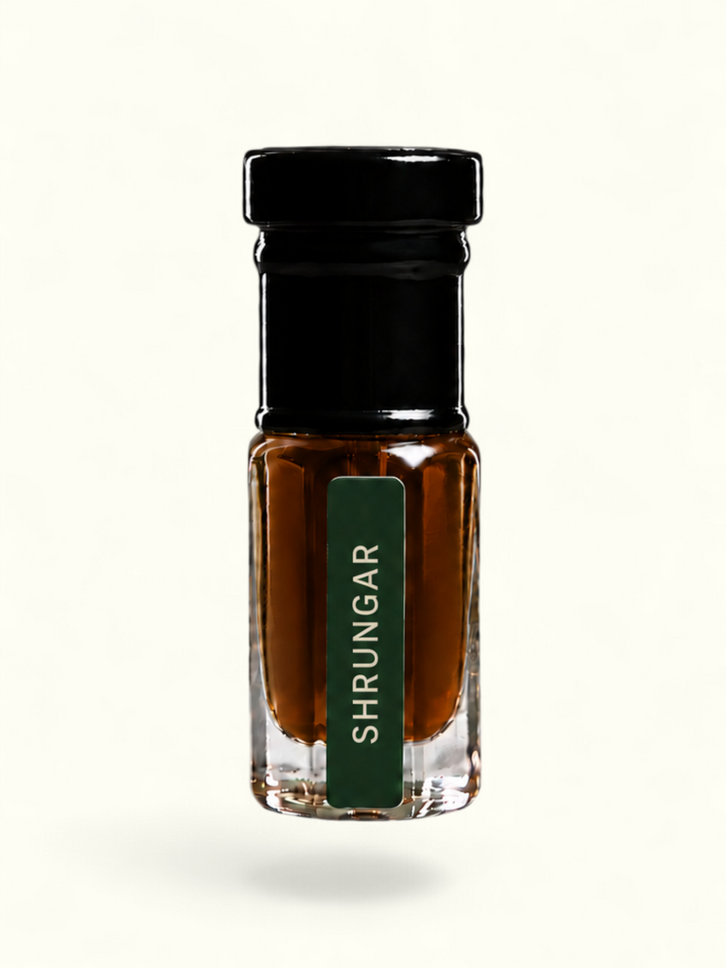 A small clear glass bottle with a black cap and a dark green vertical label reading 'SHRUNGAR' in white text, filled with amber-brown liquid, centered on a plain white background.