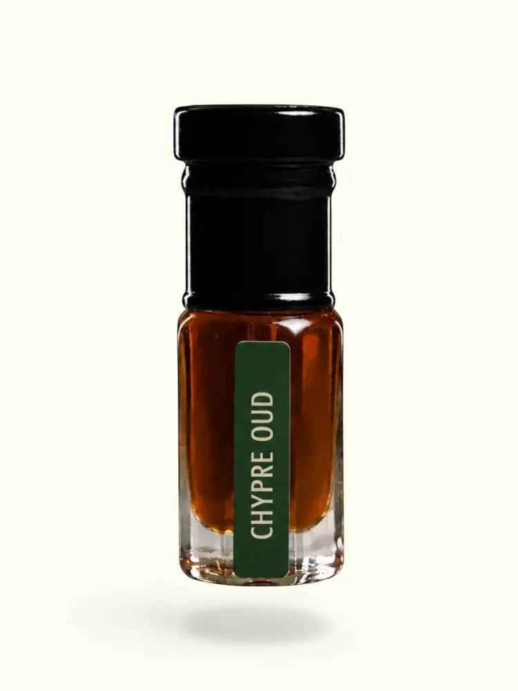 PERFUME BAY Chypre Oud attar in a small glass bottle with a black cap and green label against a cream background.
