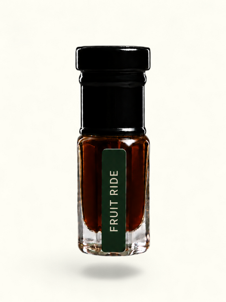 A small clear glass bottle with a black cap and a dark green label reading 'FRUIT RIDE' in white text, filled with a dark amber-brown liquid, centered on a plain white background.