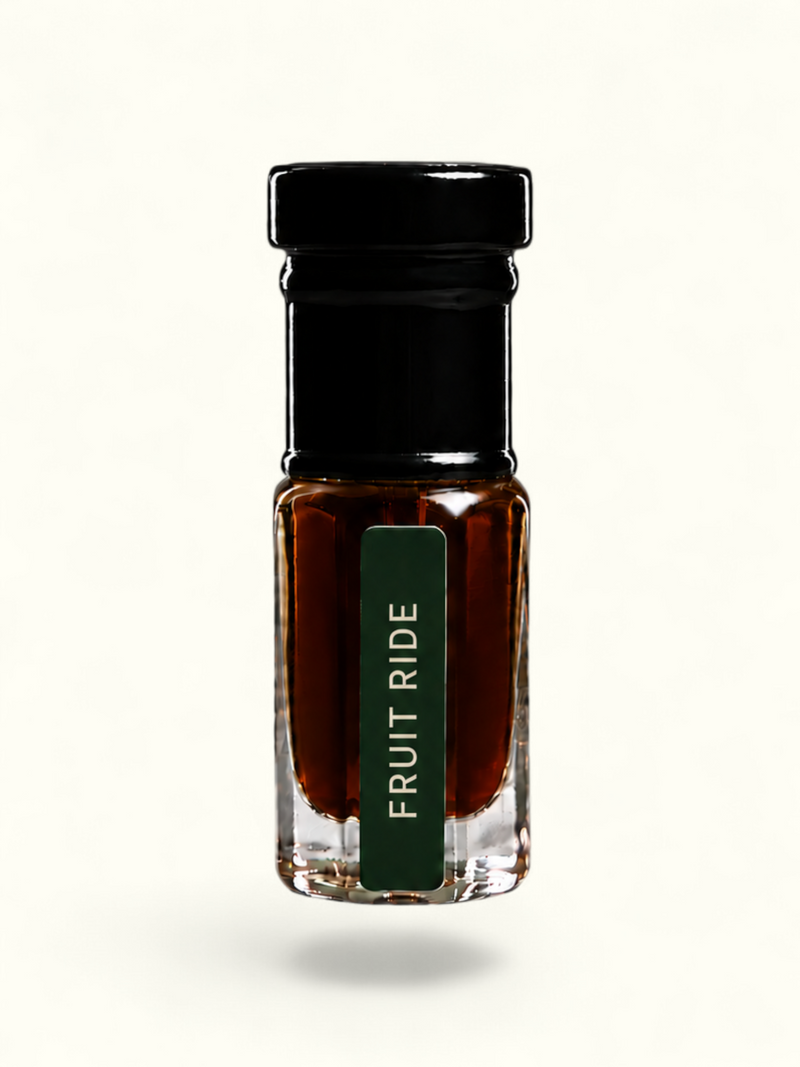A small clear glass bottle with a black cap and a dark green label reading 'FRUIT RIDE' in white text, filled with a dark amber-brown liquid, centered on a plain white background.