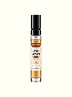 A 10 ml glass perfume roller bottle with a black spray cap, containing amber-colored fragrance oil. The label reads 'PENTO MORENO Regal Assam Eau De Parfum'.
