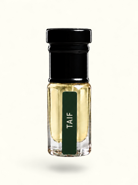 A small clear glass bottle with pale yellow liquid, a black cap, and a dark green vertical label reading 'TAIF' in white text, centered on a plain white background.