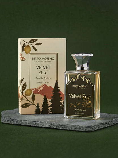 PERFUME BAY Velvet Zest eau de parfum bottle and box with botanical and mountain illustrations on a slate surface.