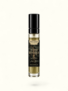 A 10ml perfume bottle of Vetiver Mystique by Perito Moreno, featuring a black cap, a black label with gold lettering, and golden-yellow liquid inside a clear glass bottle, set against a plain white background.