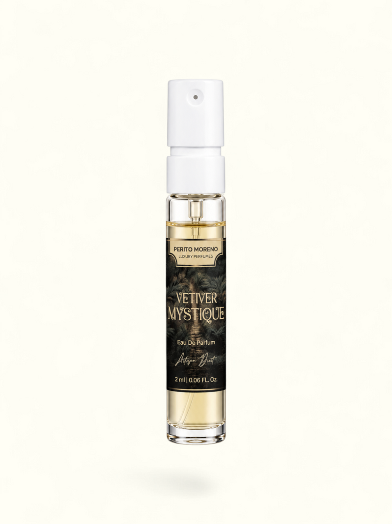 A 2 ml clear glass perfume spray bottle with a white atomizer cap, containing light amber liquid. The bottle features a black label with gold lettering that reads 'PERTO MORENO CAYE PERFUMES' and 'VETIVER MYSTIQUE'.