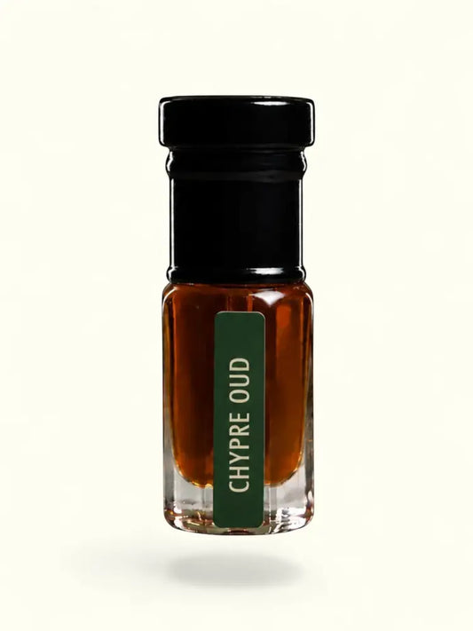 PERFUME BAY Chypre Oud attar in a small glass bottle with a black cap and green label against a cream background.